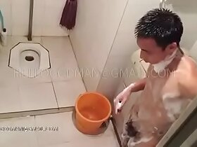 Full-grown Chinese man taking a shower