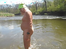 Naked Driver stands up in the river and shakes retire from